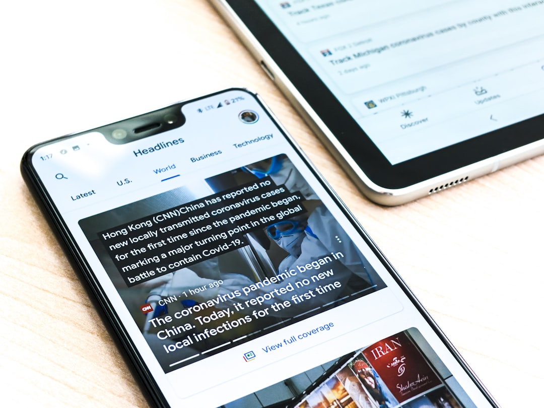 Services-01 A Google pixel 3XL showing Covid-19 information from the Google News app sits on a wooden table next to a Samsung Galaxy Tablet.